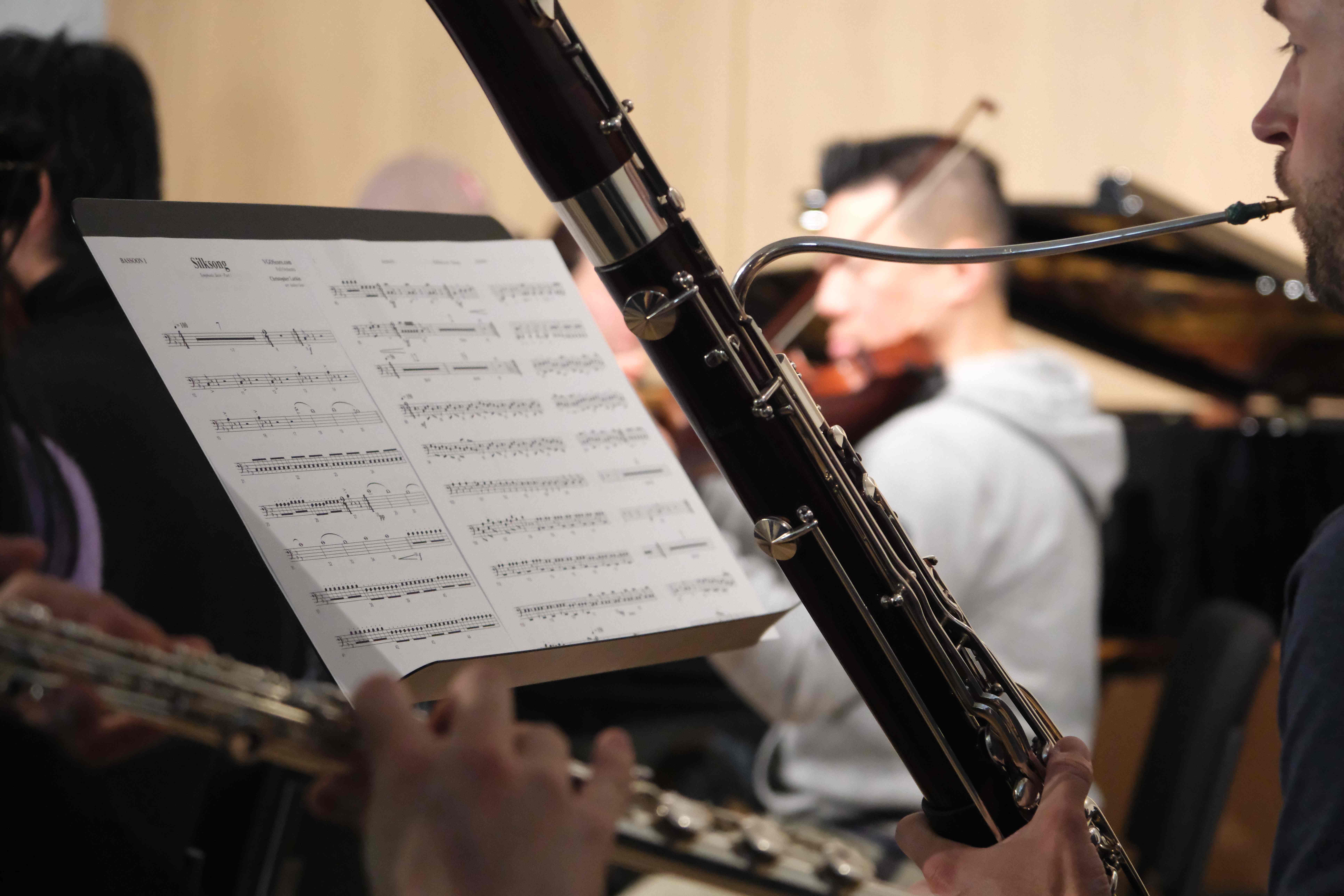 Close-up of a bassoonist playing with sheet music