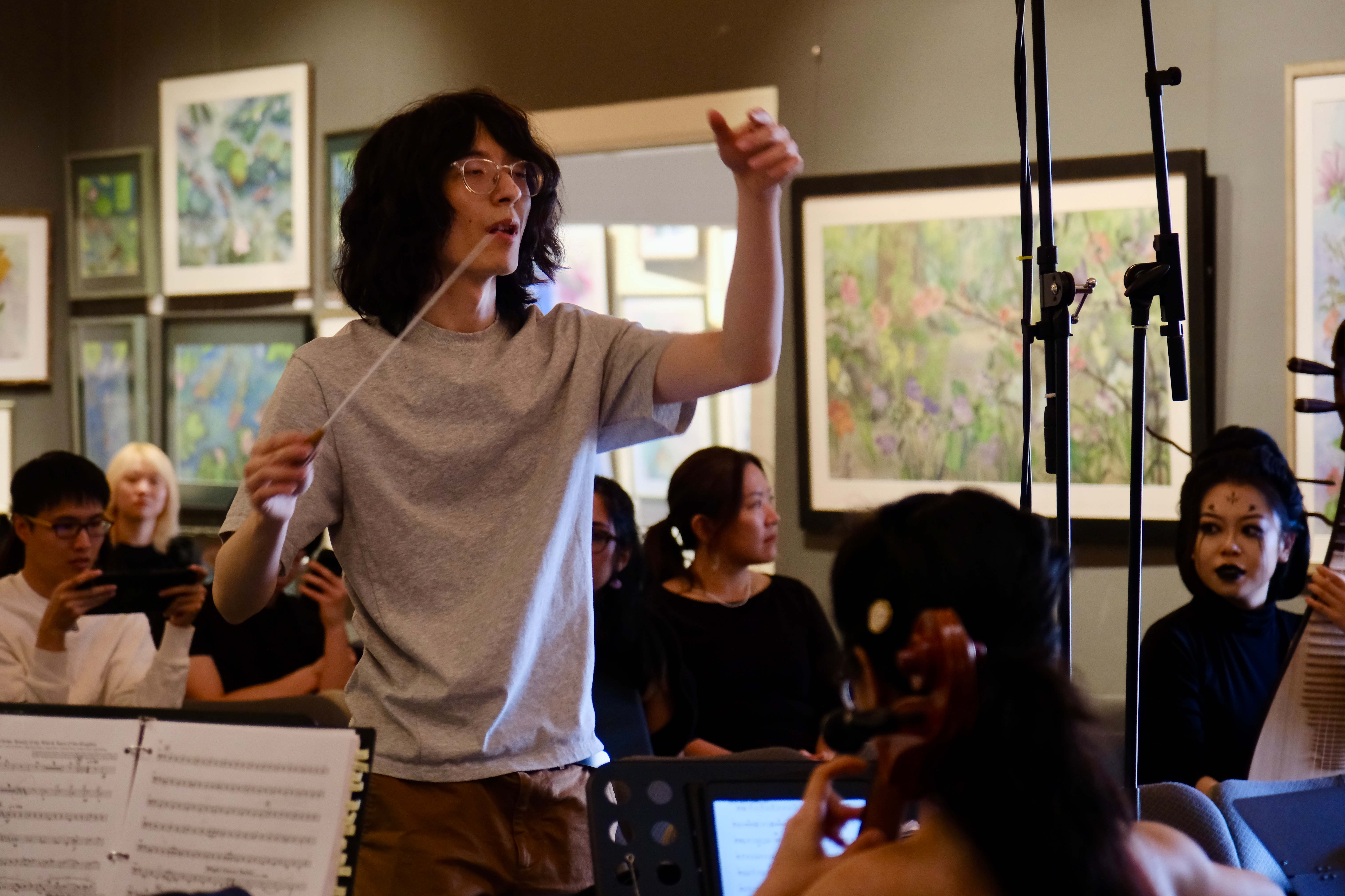 Conductor leading the GG Orchestra during rehearsal