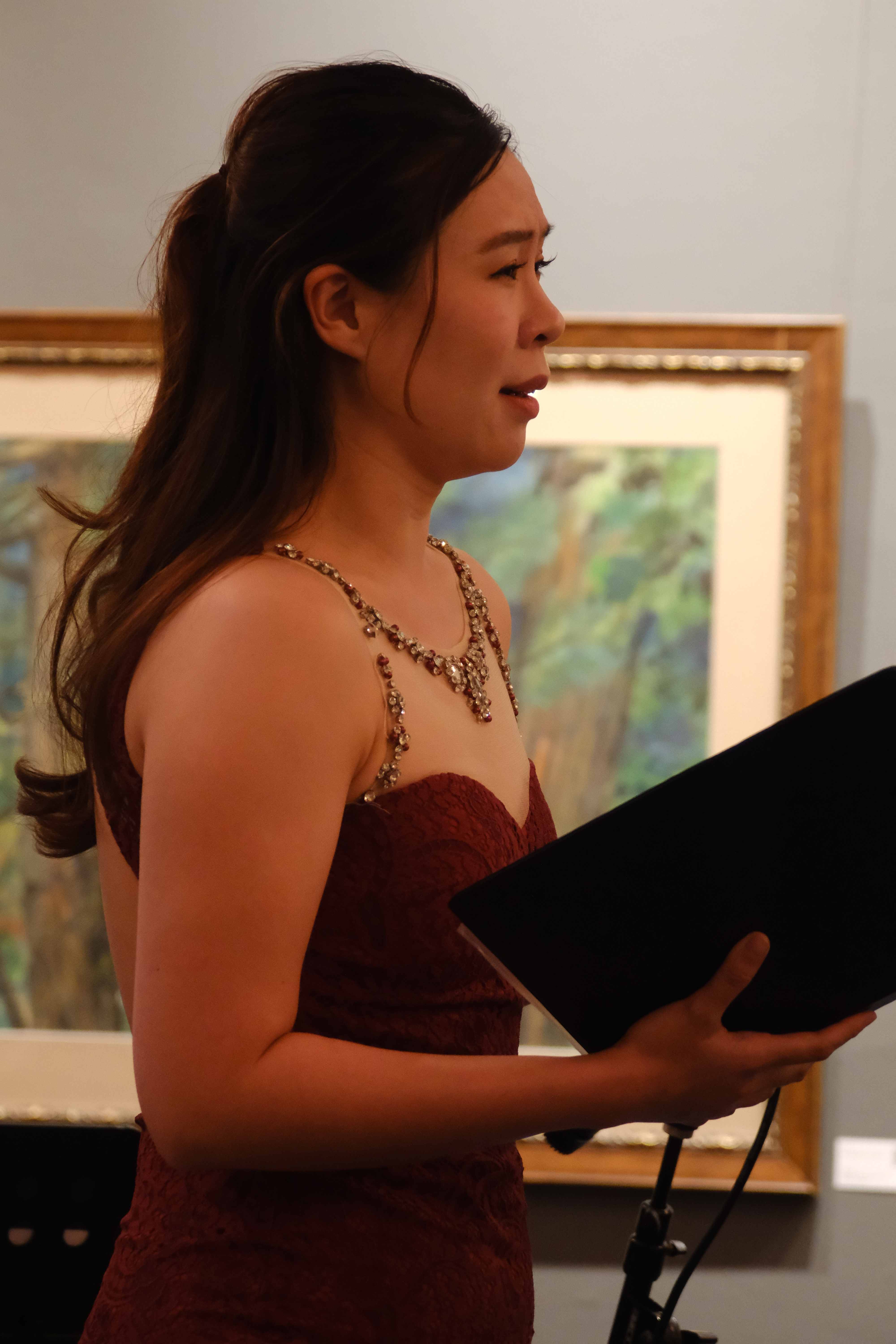 Soprano soloist in burgundy dress performing